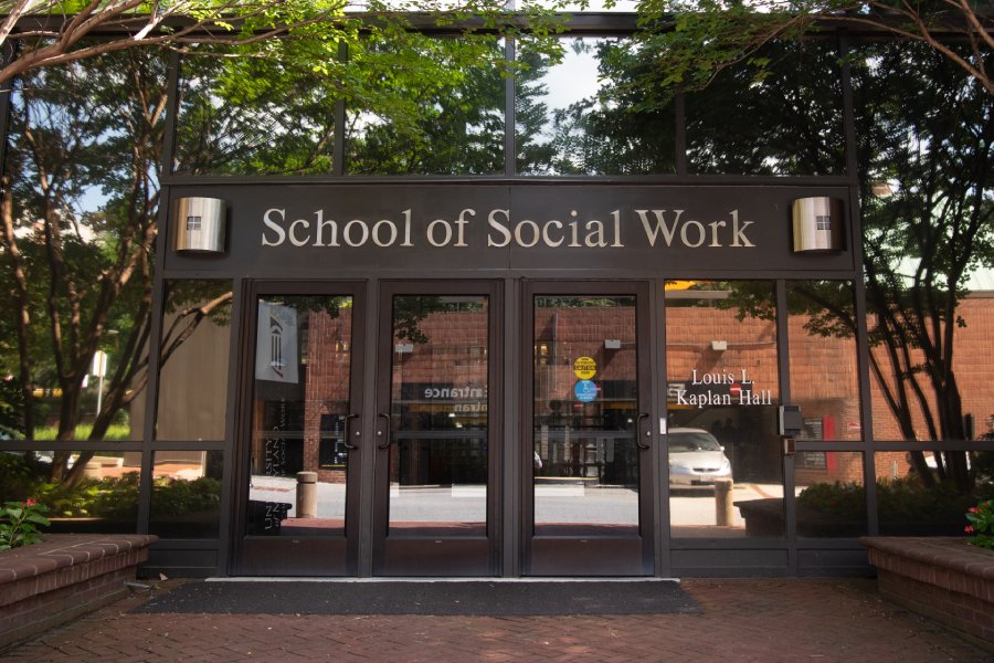 Students and faculty gather outside of the entrance to the University of Maryland School of Social Work.