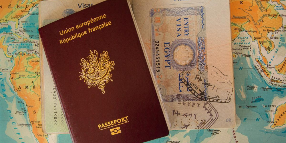 Passports sit on a table covered in a map