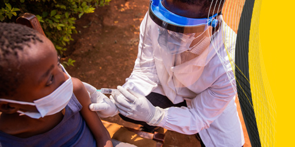 A doctor gives a young boy a vaccine