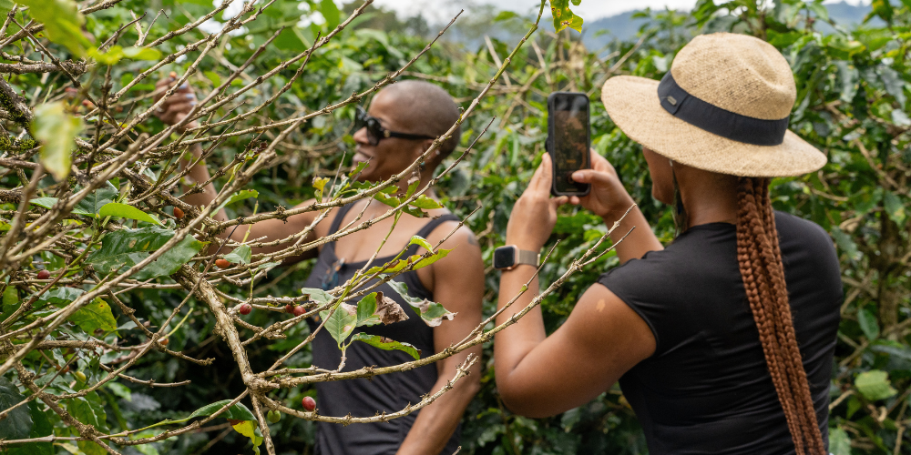 A woman takes a photo of another outside in Costa Rica.
