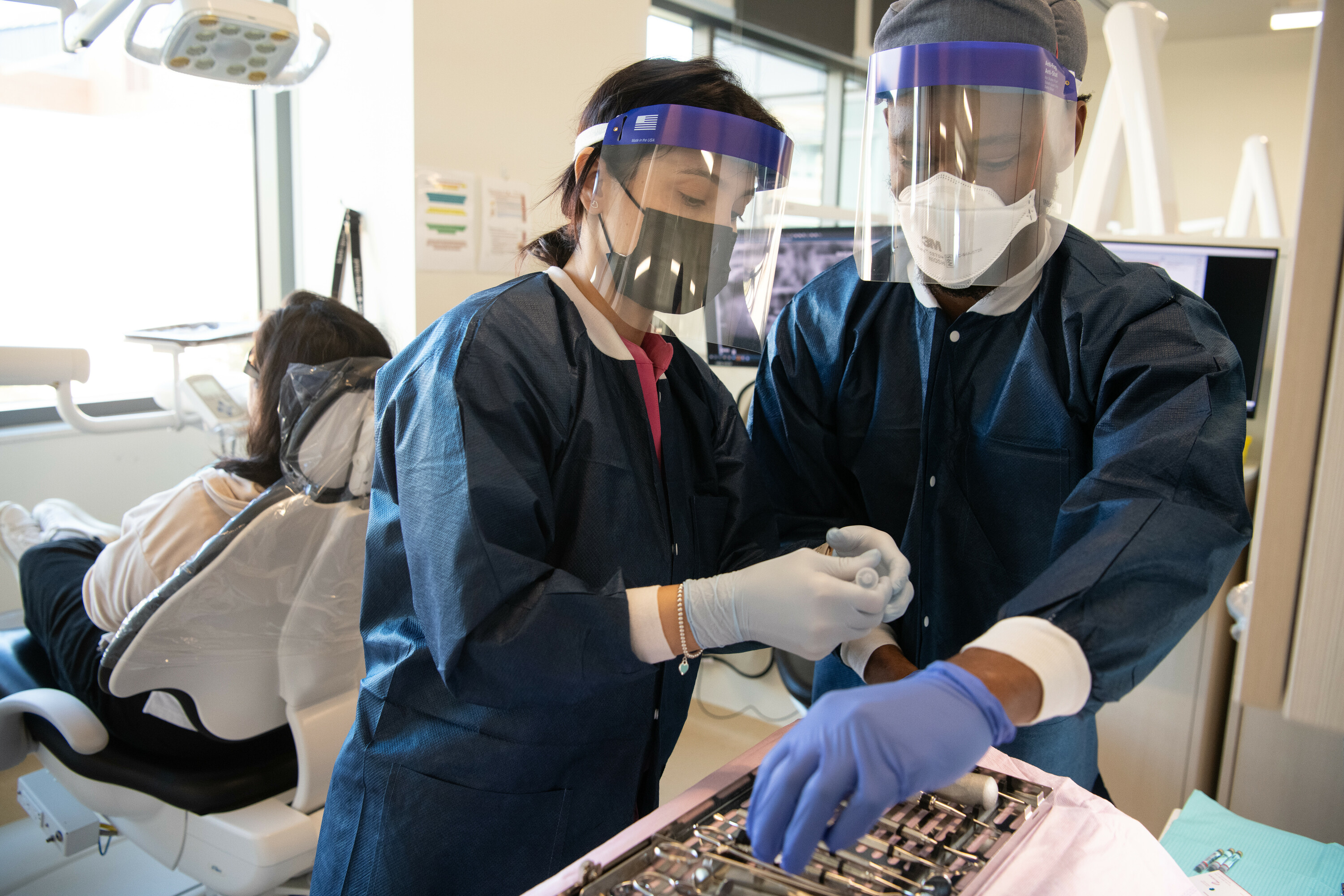 Dentistry students working with a patient