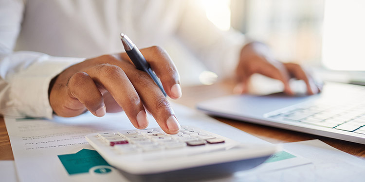 person uses a large desk calculator