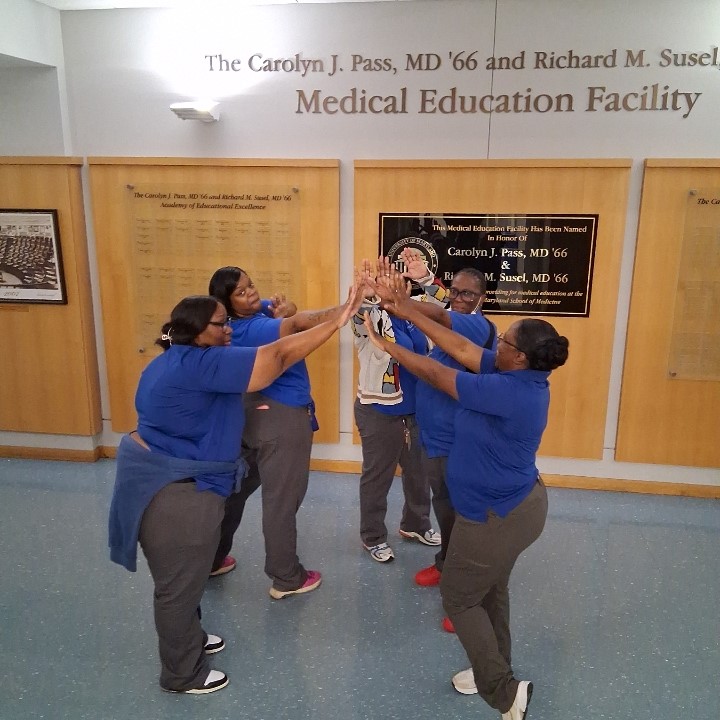 EVS employees with hands in circle