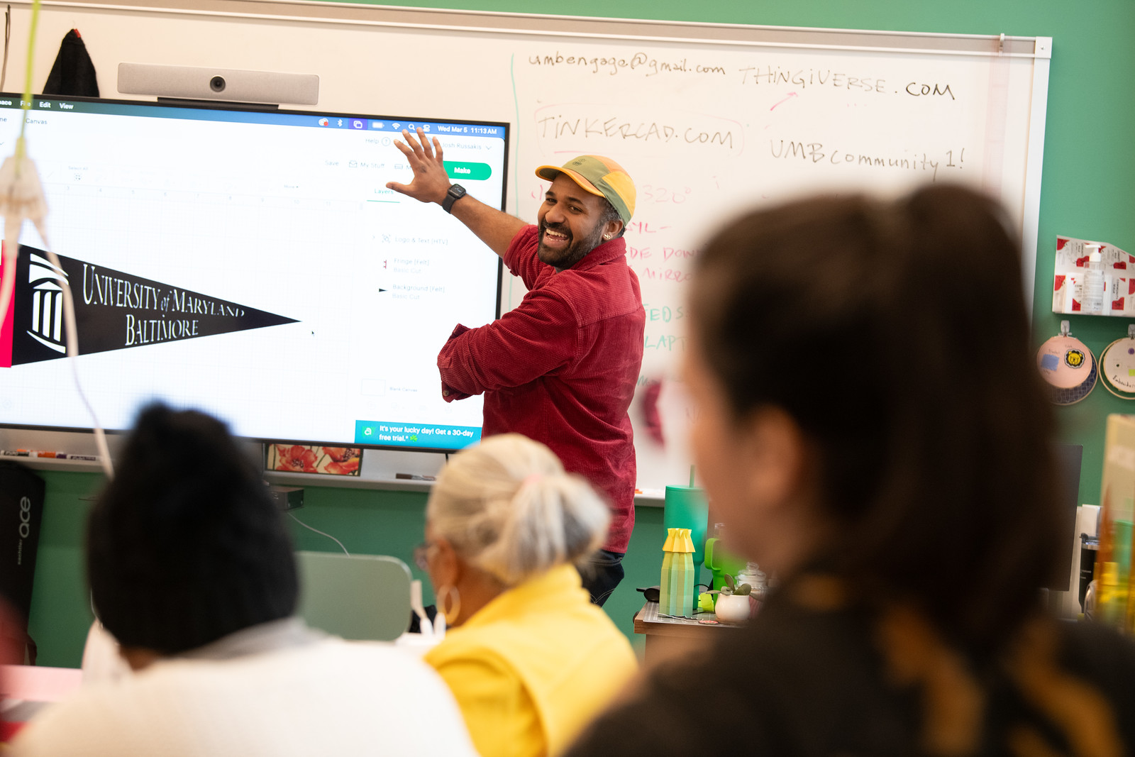 instructor showing a board in the front of class room,  teaching a class