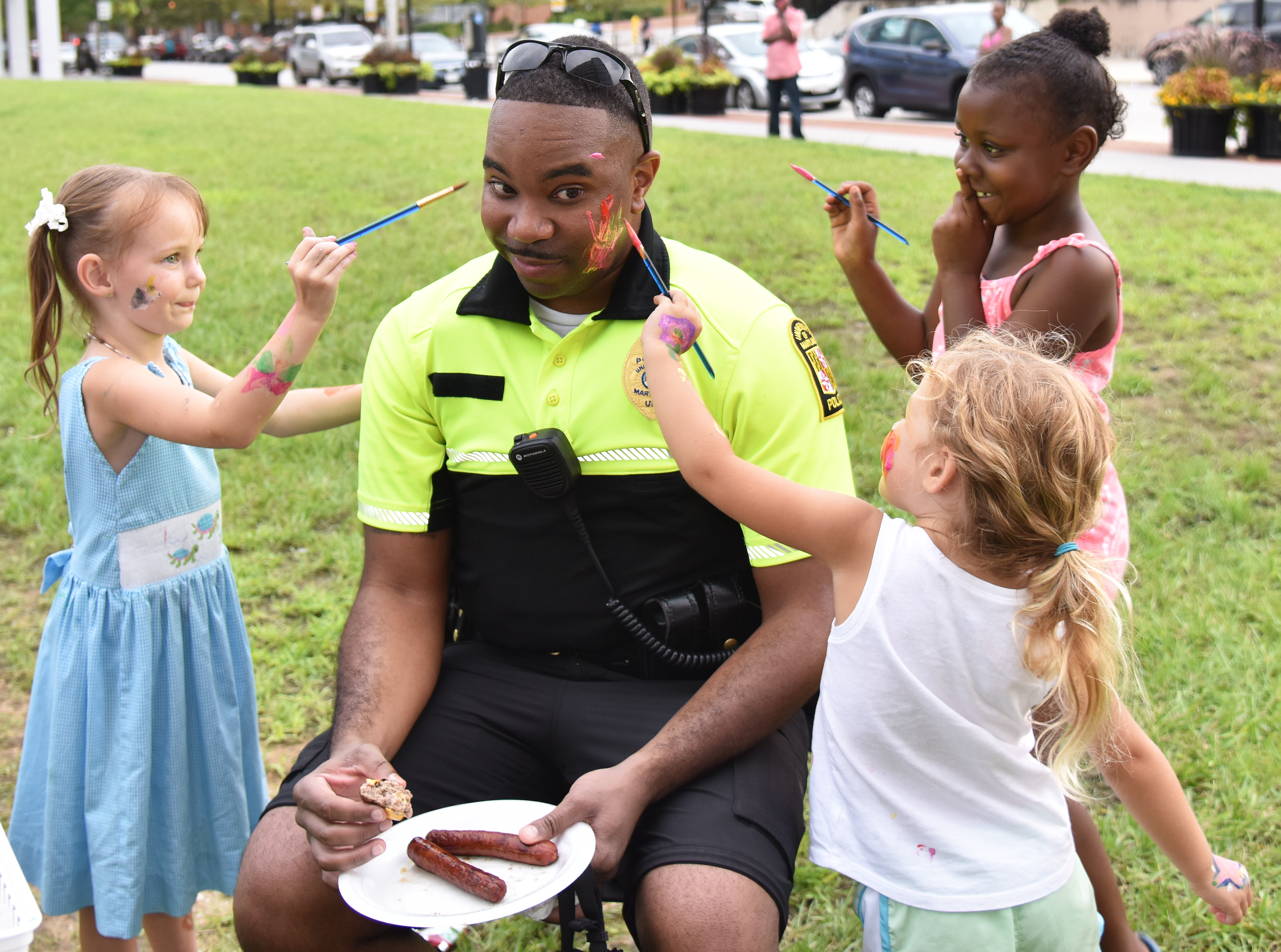Police Officer Getting is face painted by children