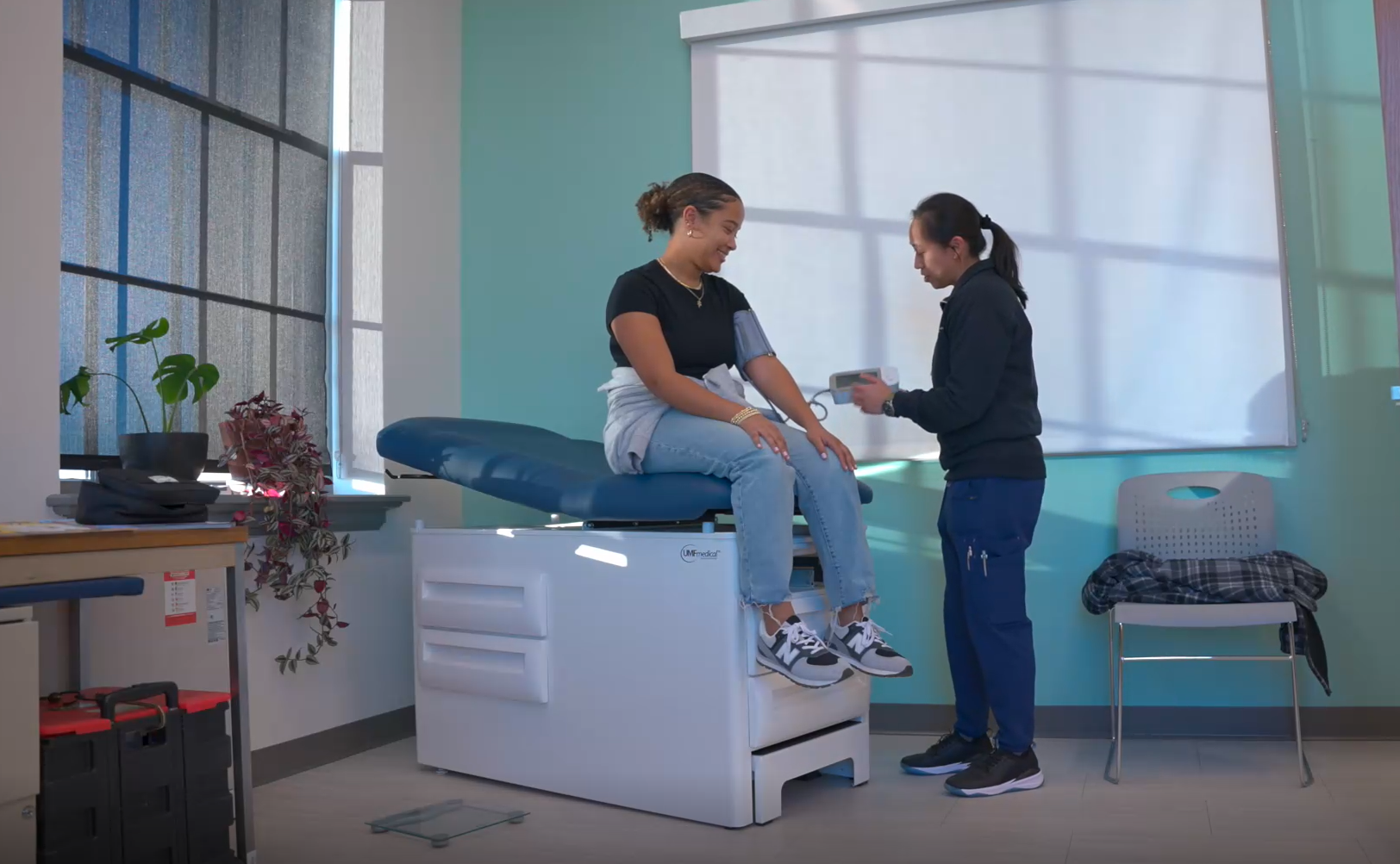 a care provider helping a patient in a medical room