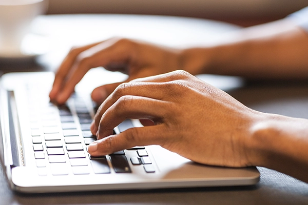 Typing on a laptop
