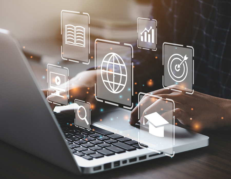 A laptop showing icons for the internet, search, digital books, online learning