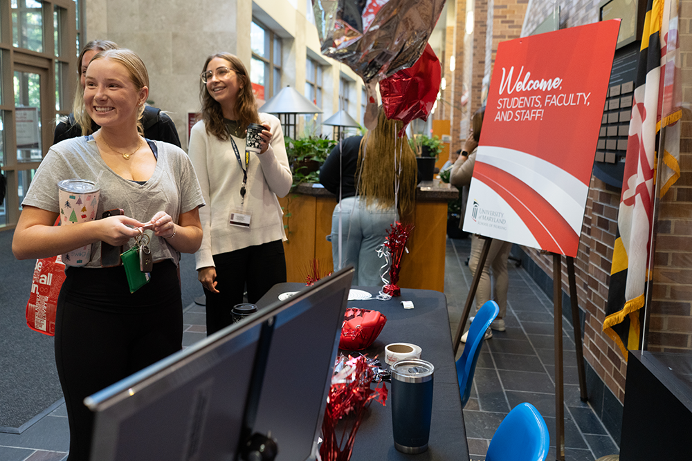 Students in front of a sign