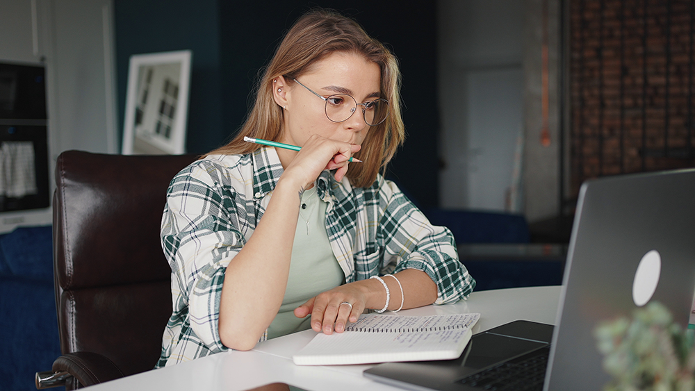 person writing on a computer