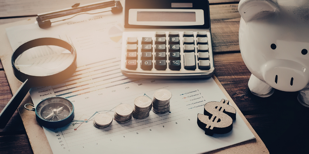 A calculator, change, piggy bank