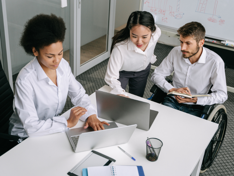 Three people work together