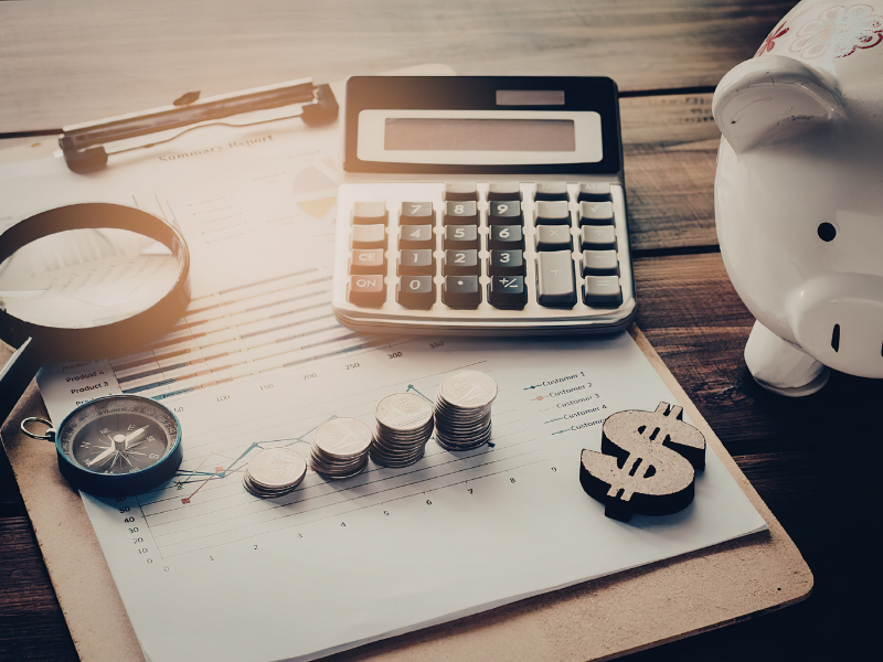 A calculator, change, piggy bank