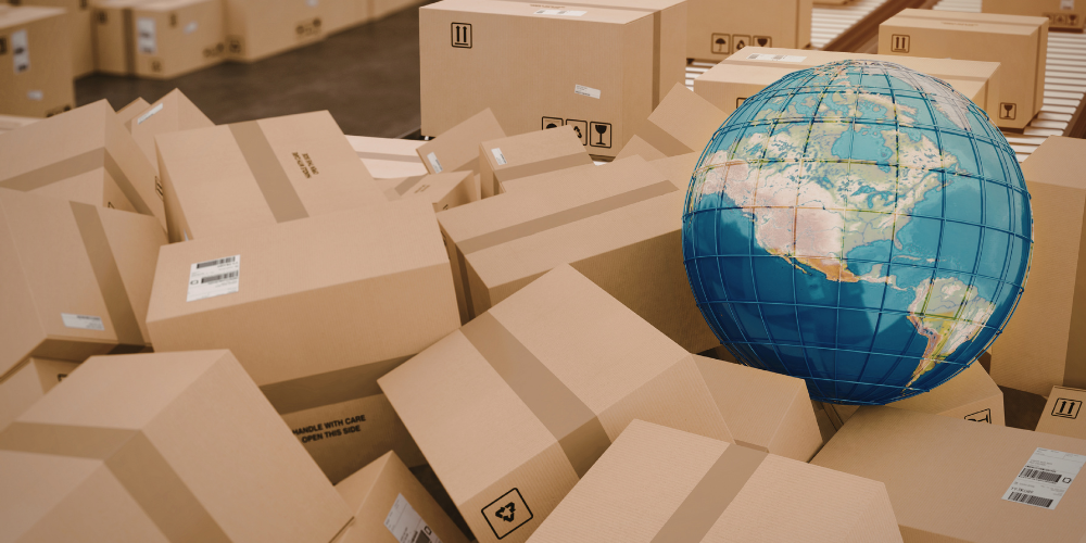 A globe sits among shipping boxes
