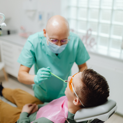 A dentist works on a patient