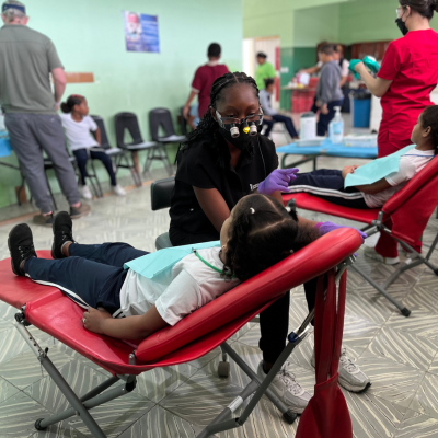 A dentistry student treats a child in Dominican Republic