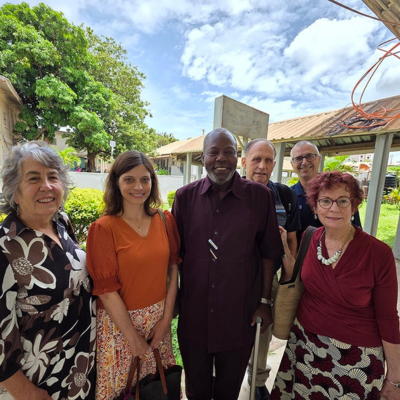 Dr. Melissa McDiarmid and Dr. Joanna Gaitens pose with colleagues in The Gambia