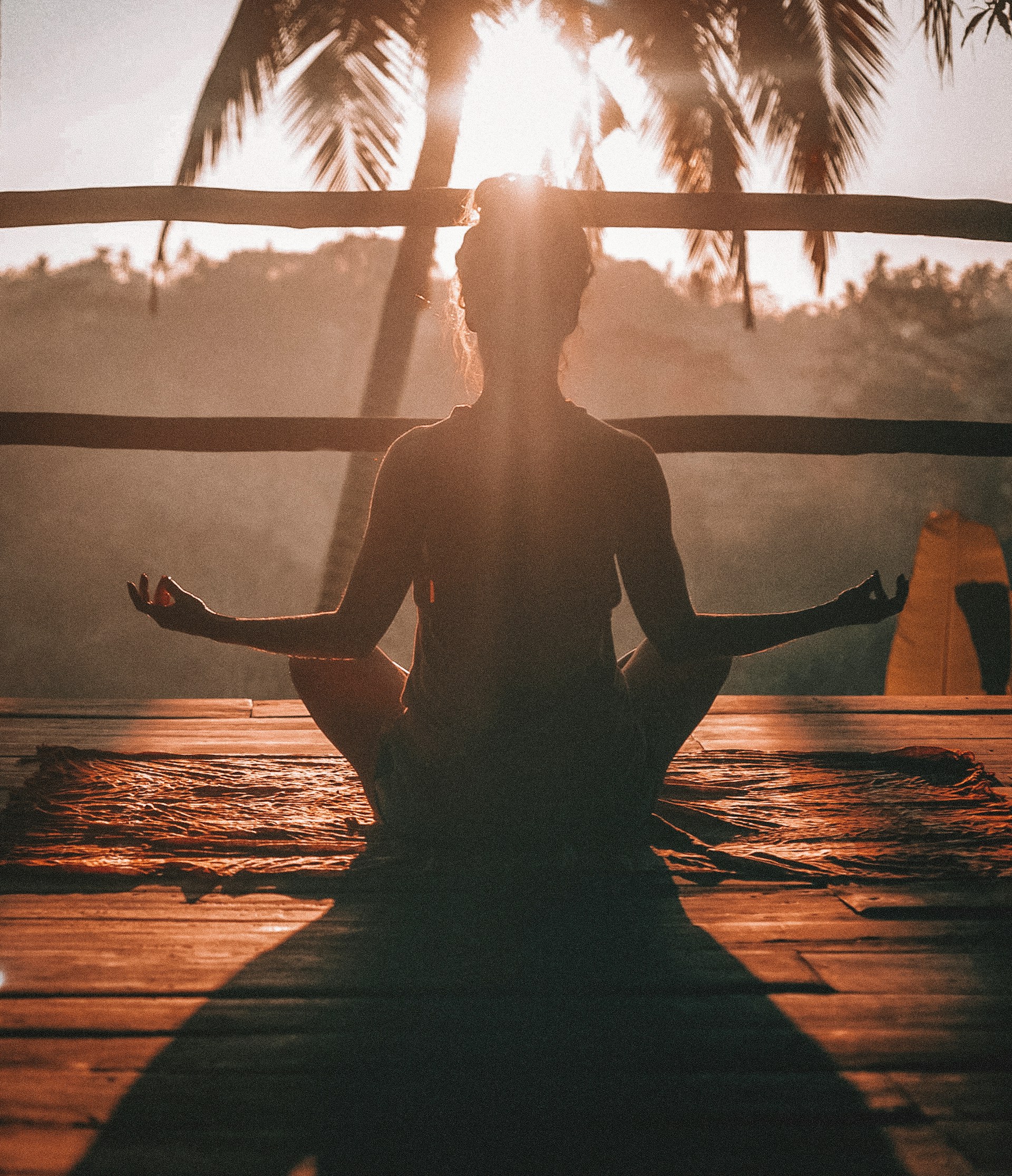 girl performing meditation outdoors in silhouette