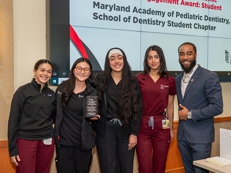 Students accepting award with IPACE Program Specialist Jordan Lyles