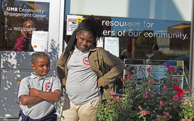 Michelle Jones, 6, and LaVera Jones, 11, of West Baltimore head to UMB's Community Engagement Center for a costume giveaway before Halloween.