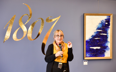 Patricia Hoffmann of Human Resources discusses her acrylic on canvas piece, “Flow.”