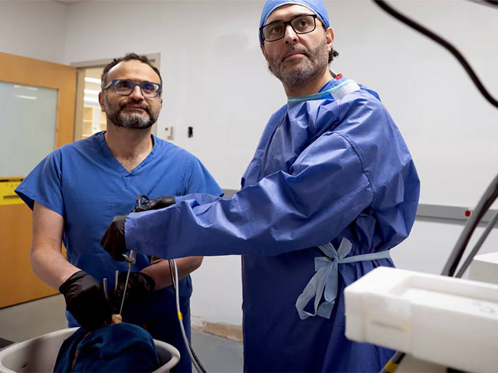 Two UMB surgeons remove a tumor through the patient's eye socket.