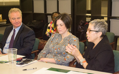 U.S. Rep. Chris Van Hollen of Maryland’s 8th District listens to Promise Heights executive director and SSW assistant dean Bronwyn Mayden, MSW, right, as Promise Heights program director Rachel Donegan, JD, listens.