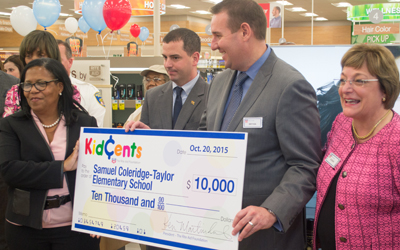 Rite Aid Corp. officials present a replica check from the Rite Aid Foundation to Principal Bettye Adams of The Historic Samuel-Coleridge Taylor Elementary School, a Promise Heights partner.