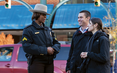 Police officer talks with two students