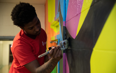 Students at Renaissance Academy put the finishing touches on the new mural. 