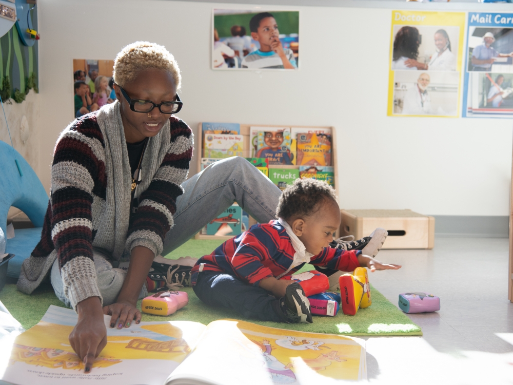 A child being read to at the Rise Early Learning and Family Support Center.