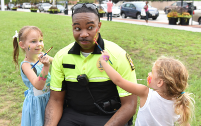 Two young artists practice their craft on Sgt. Johnson’s face.