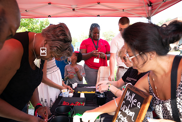 People of all ages join in the fun at the keychain-making station, one of several creative activities at this year’s Juneteenth celebration.