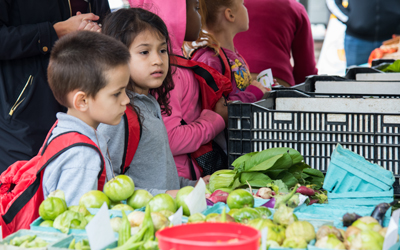 Students from James McHenry Elementary/Middle School purchase produce from the Farmer's Market with special 