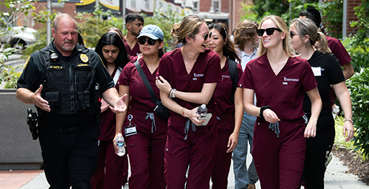 Lt. Dennis Smith giving a campus tour to dental students